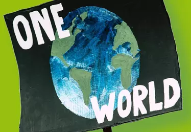 pancarte avec inscription "One Wolrd" avec la planète Terre